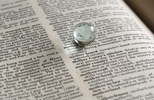 A marble sitting on a dictionary illuminating mother.